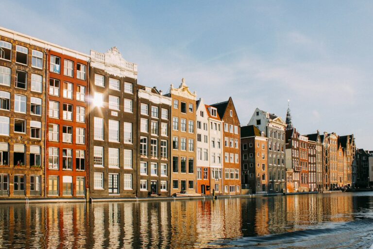 Amsterdam canal houses reflected in the water