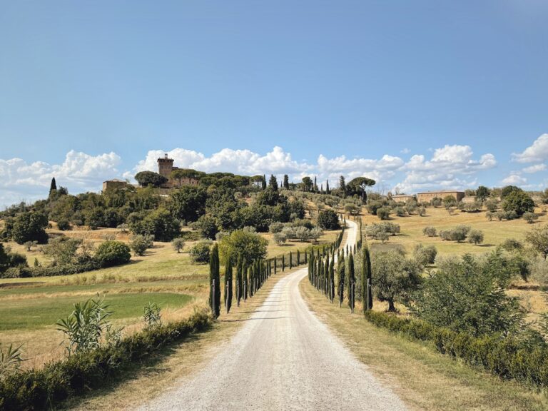 Tuscan villa and cypress avenue over Val d'Orcia hills